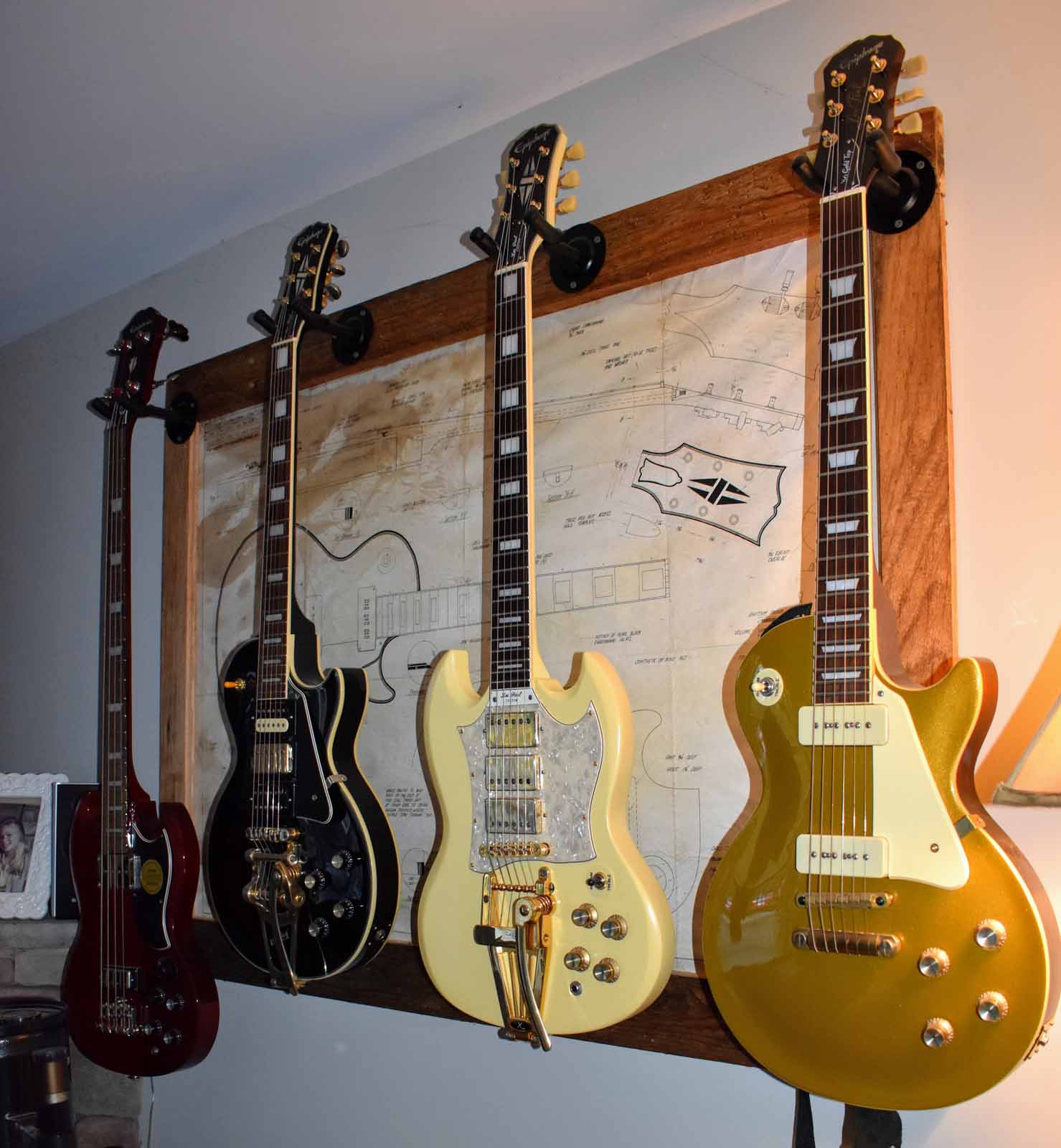 office wall of guitar axes